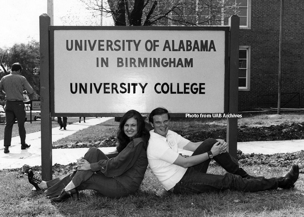 University College students relax in front of new sign