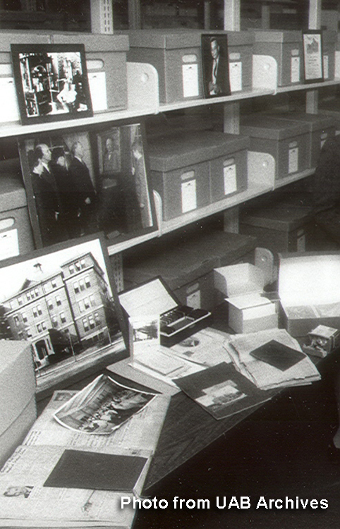 Several photographs on a table in the UAB Archives department