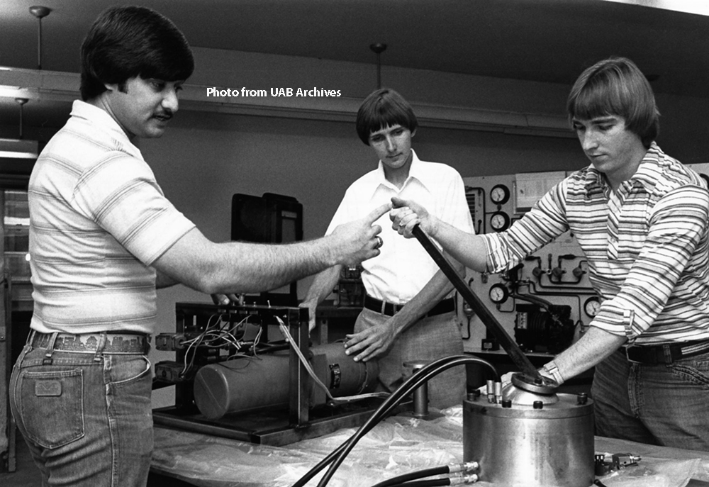Engineering students assemble a mechanical arm, June 1978