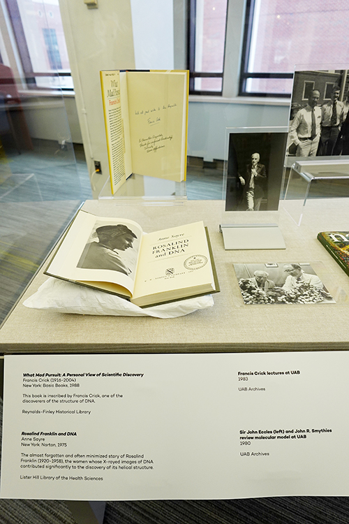 Museum case displaying genetics-related items from UAB Historical Collections.