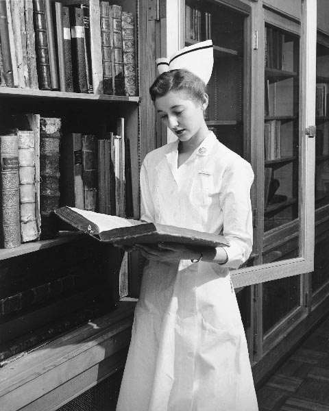 Nurse looks at a book