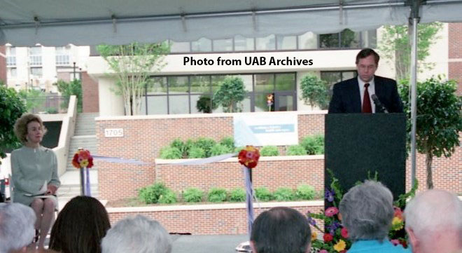 A man addresses a crowd at the new School of Health Professions building