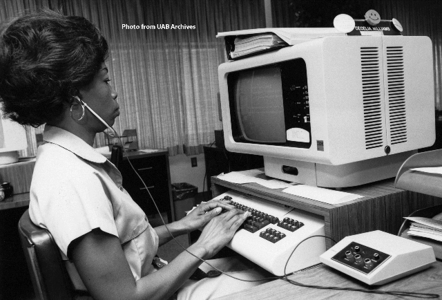 A woman types on a computer